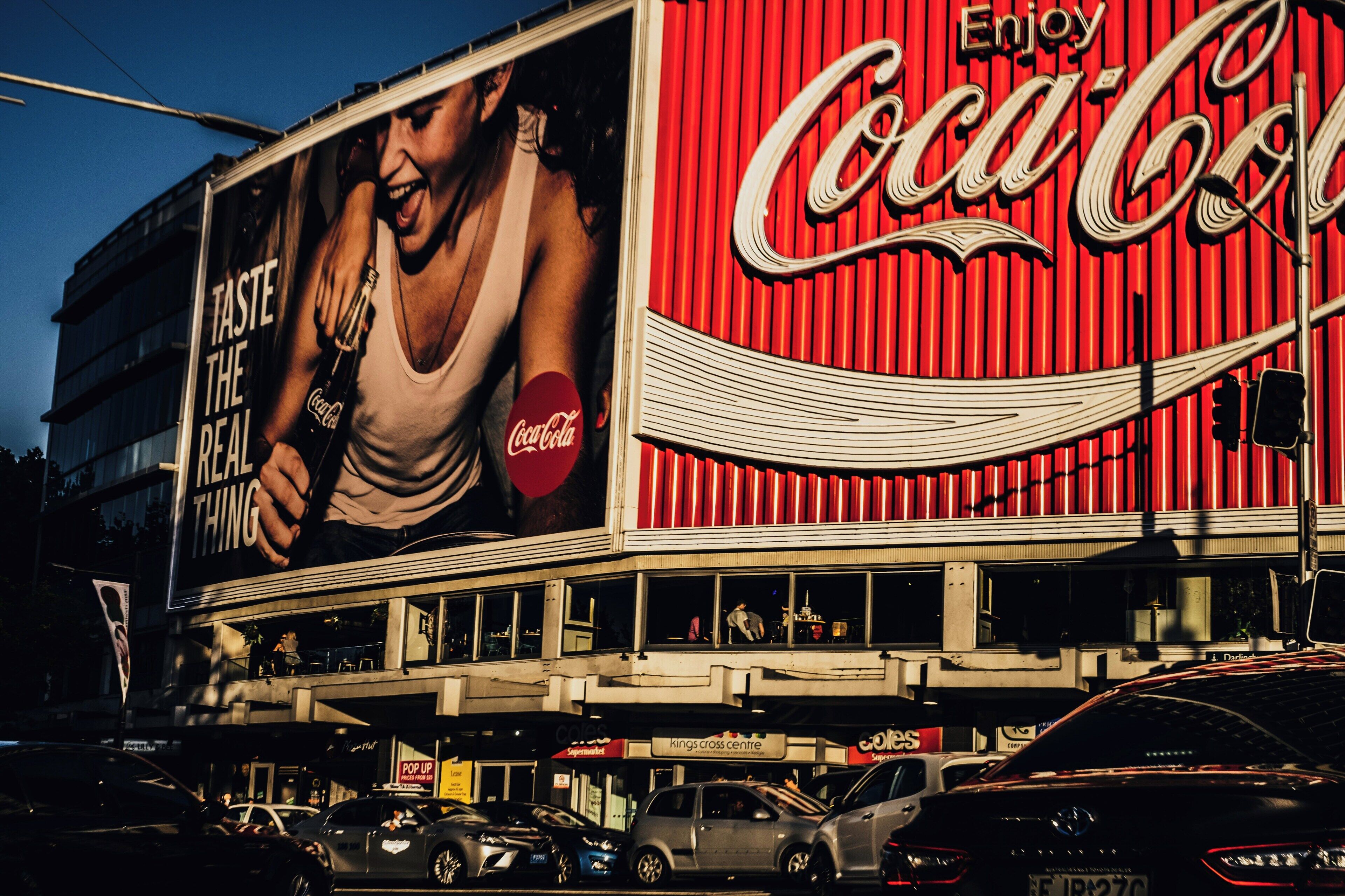 A building with a large Coca-Cola advertisement on the side.