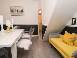 A room with a dining table, chairs, a yellow sofa, and a painting on the wall. - 50 Gladstone Avenue (Chester)