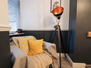 A room with a sofa, a floor lamp, and a picture frame on the wall. - 50 Gladstone Avenue (Chester)
