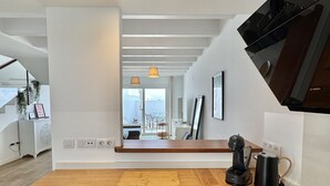 A modern kitchen with a wooden countertop, a black coffee maker, and a Bosch microwave. - Casahost Dolce Vita Villa Eira (Costa Teguise)