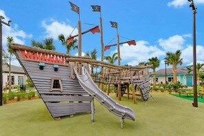 A playground with a slide, climbing structures, and a pirate-themed design. - 8-Min Disney Villa with Resort & Pool (Kissimmee)