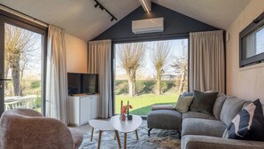Una sala de estar moderna con un sofá, una mesa de centro y un televisor.