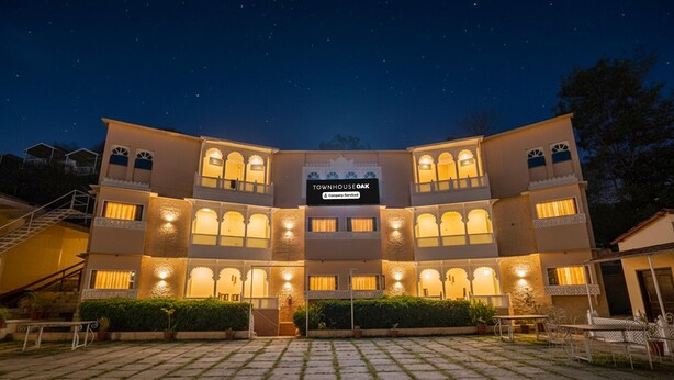 A two-story building with a sign reading 'TOWNHOUSE OAK & Company Serviced.' - Classic Kumbhal Castle (Kumbhalgarh)