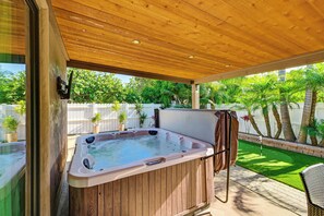 A wooden deck with a hot tub, surrounded by a white fence and palm trees. - Walk to Lagoon! Luxe Coastal Escape w/ Pool Table (Carlsbad)