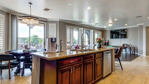 A spacious kitchen with a large island, built-in appliances, and a dining area with a pool table. - Swim-up Bar & Games! Ultimate Goodyear Group Stay (Goodyear)