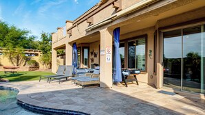 A pool area with lounge chairs, a hot tub, and a covered patio with a view of the pool. - Swim-up Bar & Games! Ultimate Goodyear Group Stay (Goodyear)