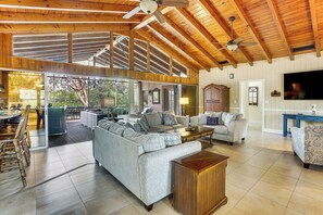 A spacious living area with a high ceiling, large windows, and a dining area with a view. - Private Pool & Dock: Riverfront 'bridge Escape' (North Fort Myers)