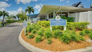 A building with a sign for 'Wheelhouse Grill' and a 'No Vehicles Past This Point' sign. - Resort-style Fort Myers Gem: Swim, Golf & Cruise! (Fort Myers)