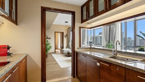 A modern kitchen with a granite countertop, stainless steel sink, and wooden cabinets. - Relaxing 1bedroom mins drive to Burj Khalifa (Dubai)