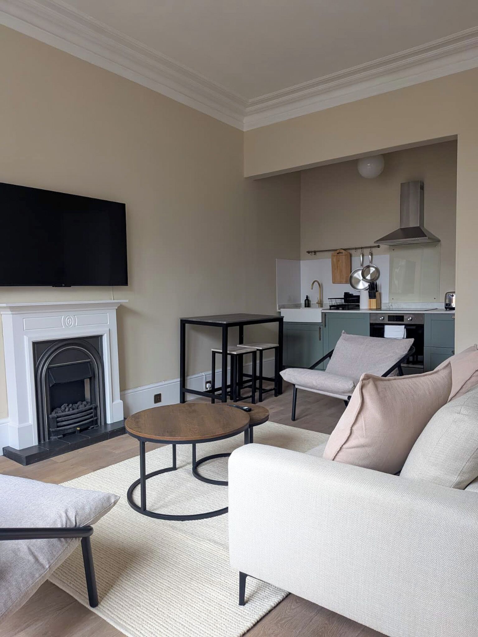 A living room with a fireplace, sofa, coffee table, and TV.