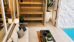 A modern living room with a sofa, coffee table, and a built-in wooden shelf unit.