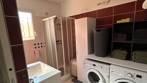 A laundry area with a washing machine, dryer, and a small sink. - Mini Villa "Mon Rêve Corse" Seaside in Residence with Swimming Pool (Cervione)
