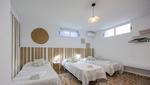 A hotel room with two beds, a round woven wall hanging, a ceiling light, and a window. - Fidalsa Grand White House (Mutxamel)