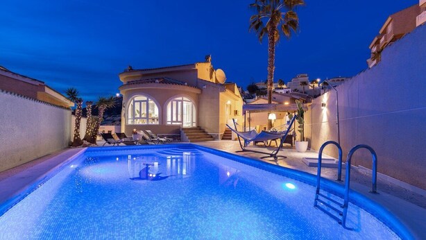 A swimming pool with a clear blue water surface, surrounded by lounge chairs and a hammock. - The Big Chill by Fidalsa (Rojales)