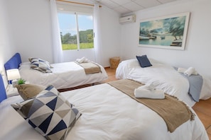 A hotel room with two beds, a large window with a view of greenery, and a painting on the wall. - Fidalsa Divine Hiding (Algorfa)