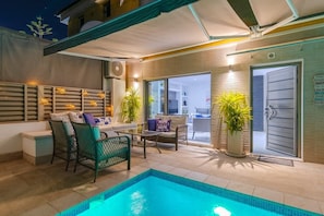A pool area with chairs and a table, a door, and a potted plant. - Fidalsa Moon Dunes Villa (Torrevieja)