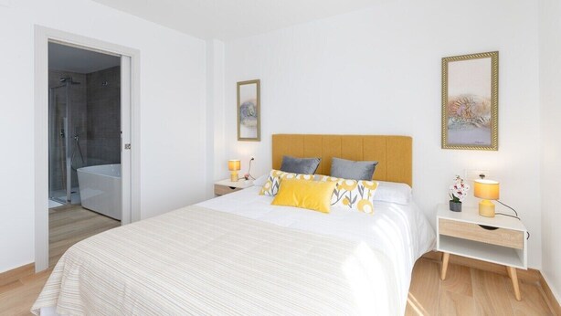 A bedroom with a bed, bedside tables, a nightstand, a shower, and a bathroom. - Beautiful Bay Views by Fidalsa (Finestrat)