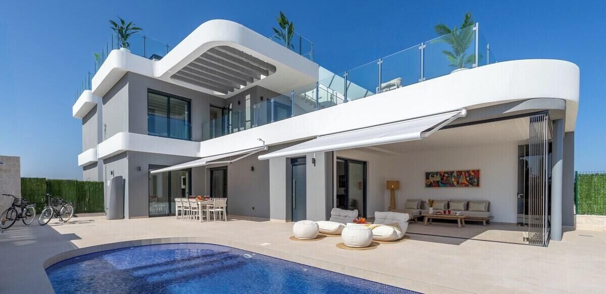 A modern two-story house with a swimming pool, outdoor seating, and a balcony.