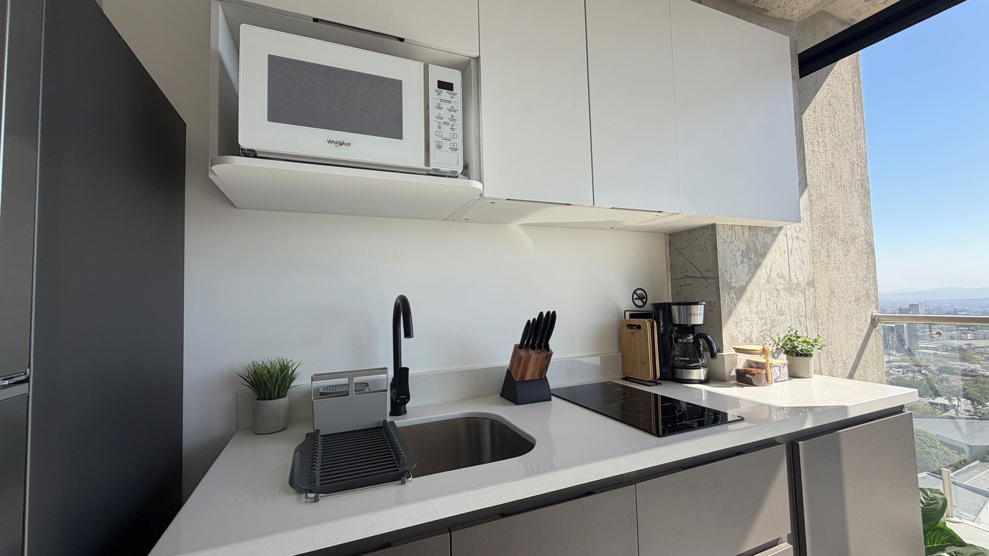 Fridge, microwave, coffee/tea maker, cookware/dishes/utensils