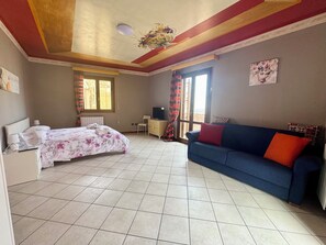 A room with a bed, a sofa, a desk, and a television. - Akragas home 2 with city view (Agrigento)