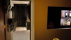 A dimly lit room with a table set for two, featuring two glasses and a tray. - The secret lodge (Dolus-le-Sec)