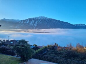View from property - 2 bed apartment (Glicine) balcony, shared pool, BBQ, mountain and lake views. (Carlazzo)