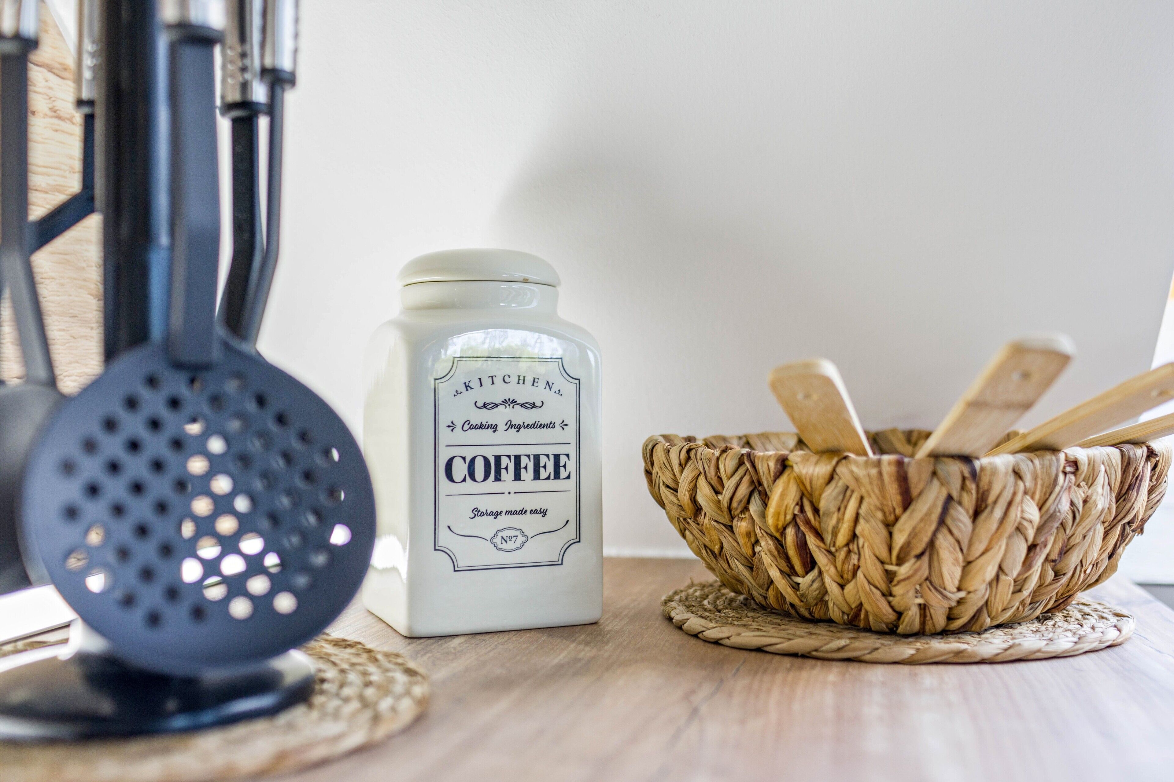 Een keuken met een koffiepot, een zeef en een gevlochten mand.