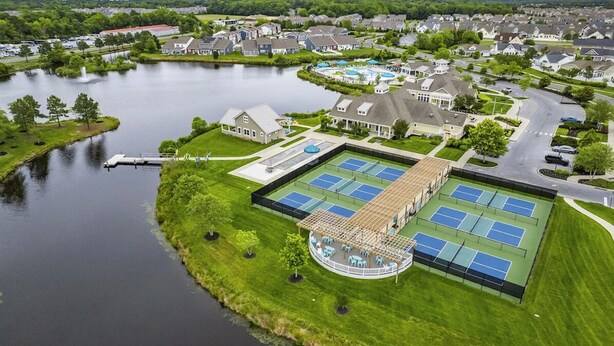 A residential area with a tennis court, a gazebo, and a lake. - Coastal Retreat • 3 Kings • Bethany Beach 5 Miles (Millville)