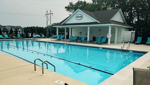 A swimming pool with lounge chairs, a lifeguard tower, and a building labeled 'Millville.' - Coastal Retreat • 3 Kings • Bethany Beach 5 Miles (Millville)