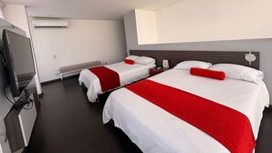 A hotel room with two beds, a flat-screen TV, an air conditioning unit, and a bench.