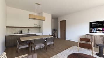 A modern kitchen with a dining area, a TV mounted on the wall, and a wooden floor.