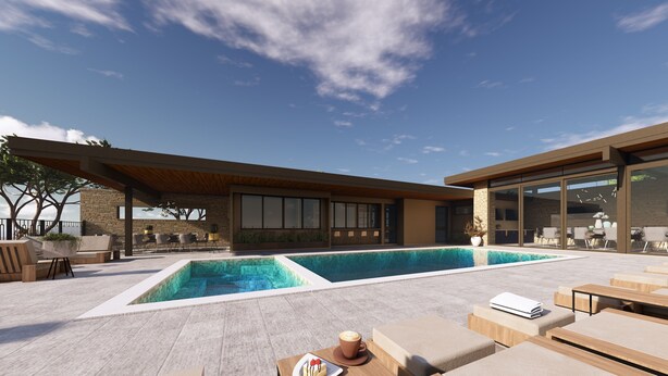 Un espace piscine extérieur moderne, doté de chaises longues et d’un bâtiment à la façade en pierre.