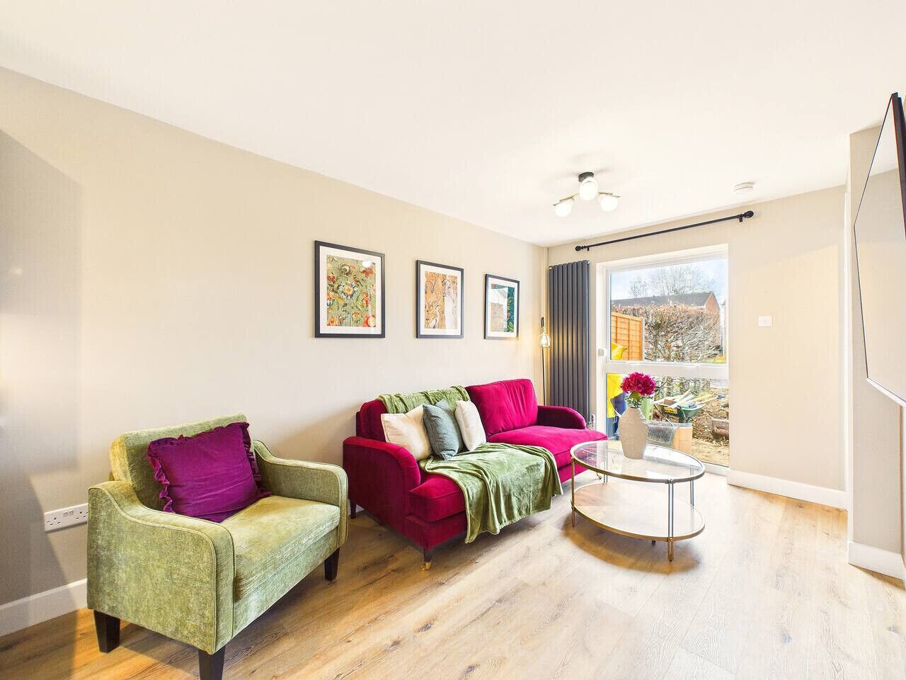 A modern living room with a sofa, armchair, and a small round table.
