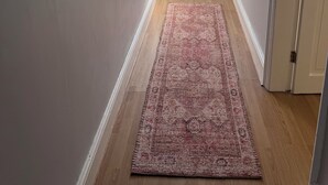 A hallway with a white door, a mirror on the wall, and a patterned rug on the floor. - Cosy 3 bedroom house in Sale, Manchester (Sale)