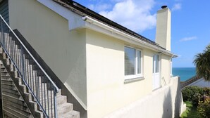 A two-story house with a concrete staircase and a view of the sea. - Wootton Gray (Penzance)