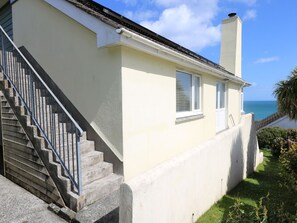 A two-story house with a concrete staircase and a view of the sea. - Wootton Gray (Penzance)