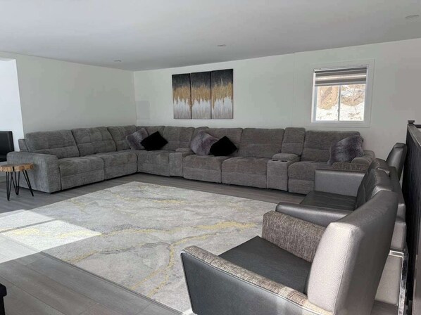 A living room with a sectional sofa, a coffee table, and a rug.