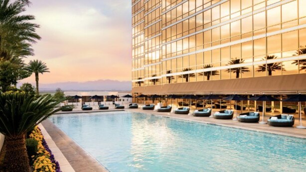 A modern hotel with a large pool, palm trees, and a view of the mountains. - 1-Bedroom / 1BB / Suite at Trump International Hotel Las Vegas - F1 Weekend!!! (Las Vegas)