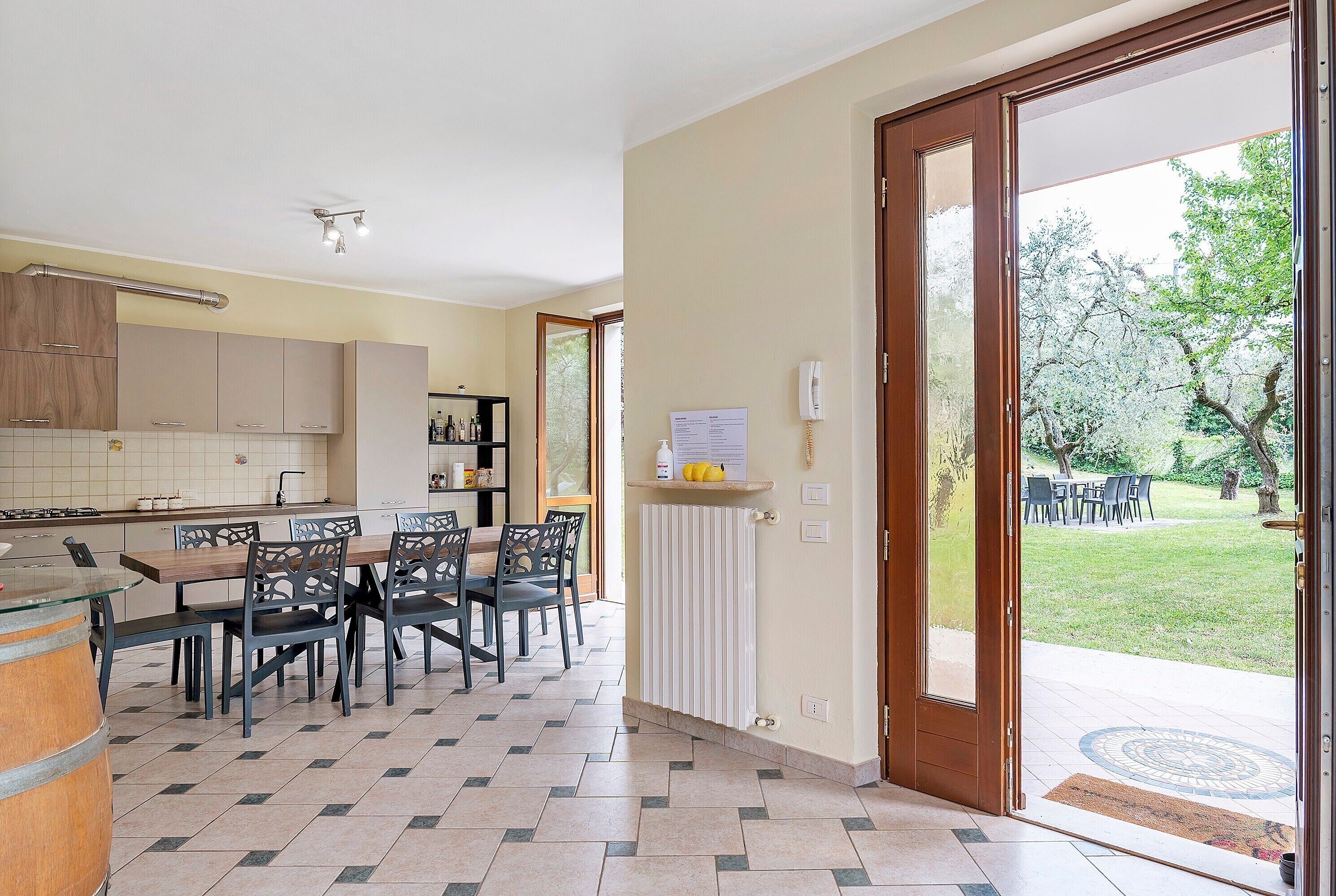 Una cocina con comedor, un radiador y vistas al jardín.