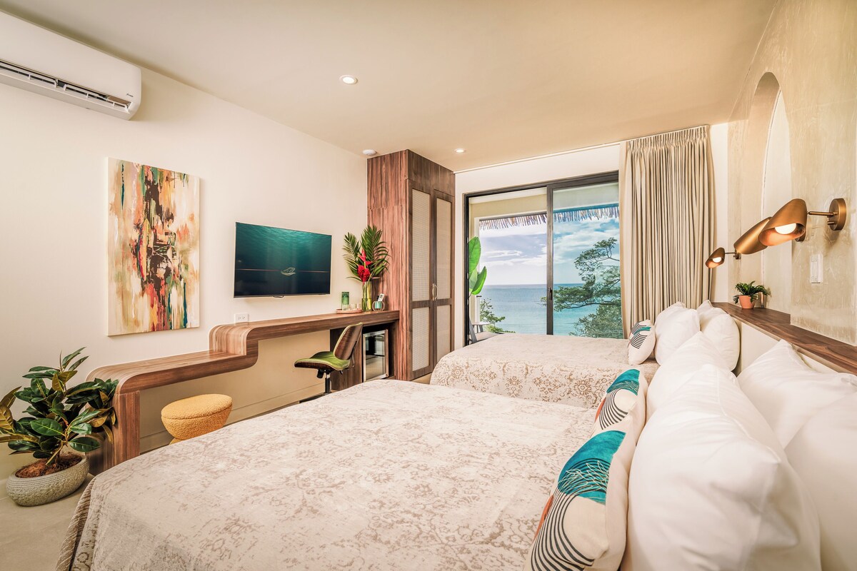 Habitación doble estándar, 2 camas Queen size, balcón, vista a la playa | Caja de seguridad en la habitación, wifi gratis y ropa de cama 
