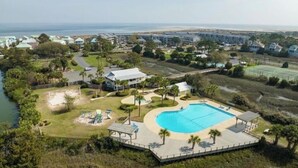 A resort with a large swimming pool, a tennis court, and a view of the ocean. - Harbor Hideaway …just steps to the beach and pool! (Harbor Island)