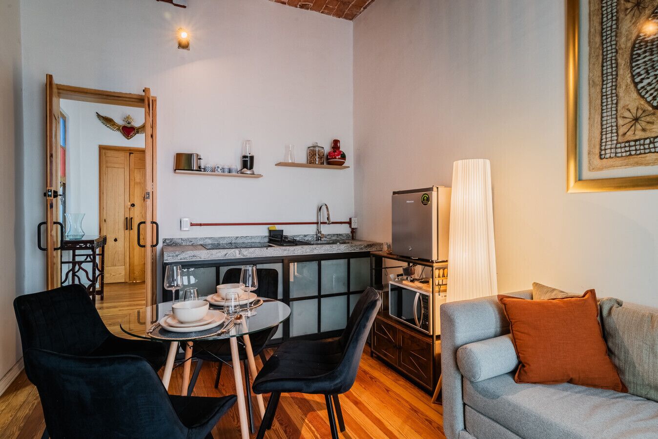 A compact living space with a kitchen, dining area, and seating.