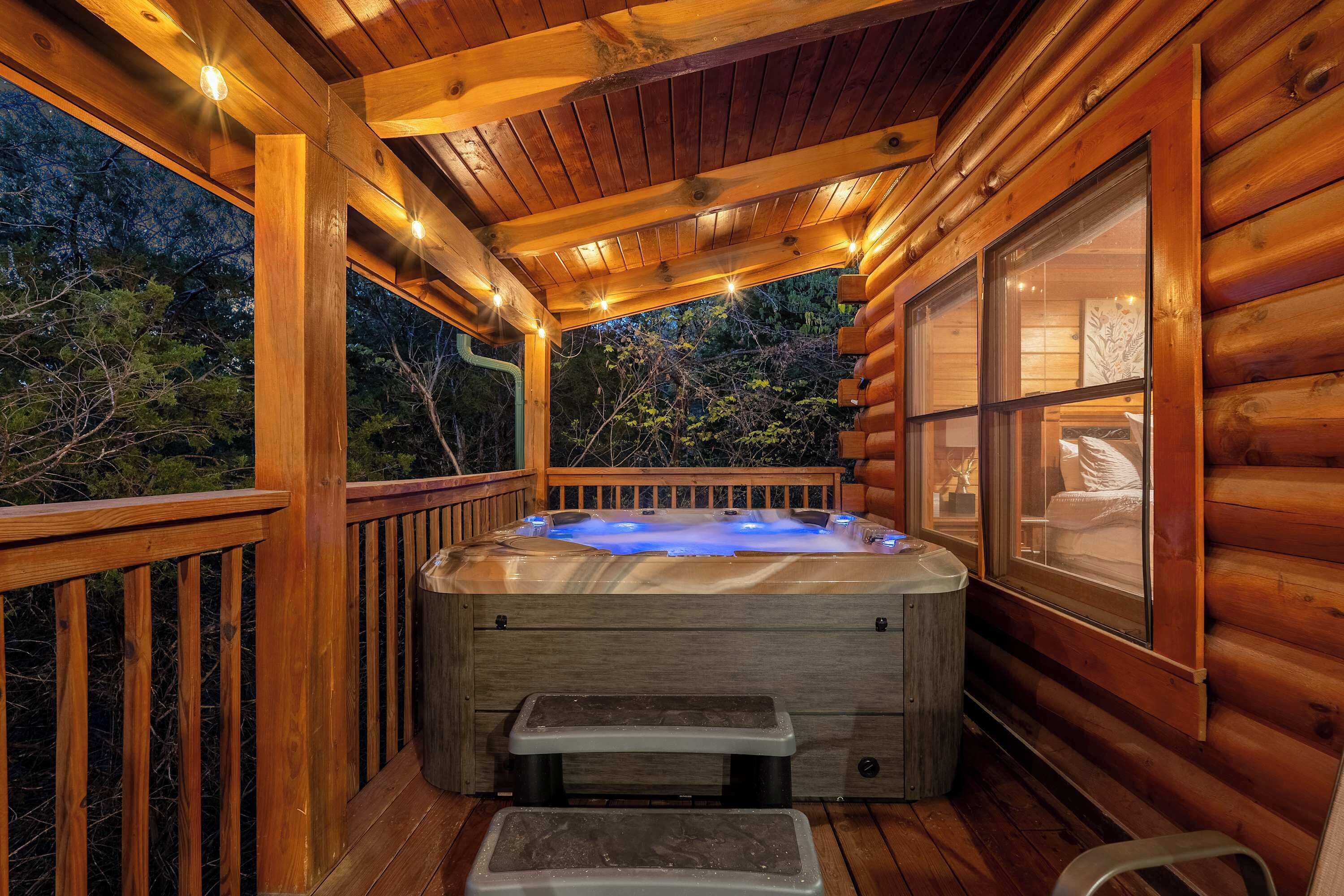 A wooden deck with a hot tub, wooden railings, and a window with a view of the outdoors.