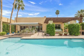 A poolside area with a covered seating area, a pool, and surrounding greenery. - Private Palm Springs Retreat w/ Pool, Spa, Mountain Views & Secluded Outdoor Living (Palm Springs)
