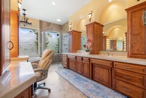 A spacious bathroom with a large vanity, a shower, and a chair. - Private Palm Springs Retreat w/ Pool, Spa, Mountain Views & Secluded Outdoor Living (Palm Springs)