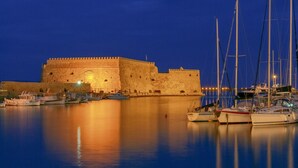 A historic stone fortress with a moat, surrounded by calm water and anchored boats. - Seaview Villa Private Pool & BBQ, 1km from Elounda (Schisma Eloundas)