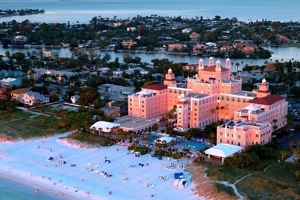 Marvel at sunset colors over a sprawling beachfront retreat.