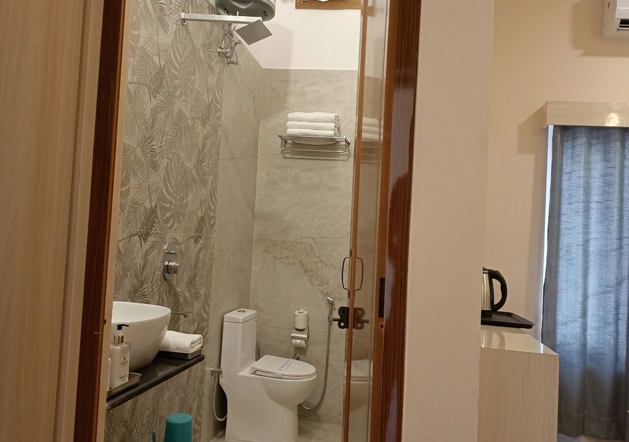 A bathroom with a sink, toilet, and shower.