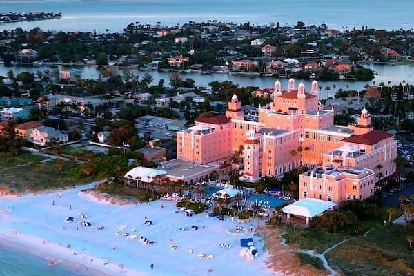 Marvel at sunset colors over a sprawling beachfront retreat.