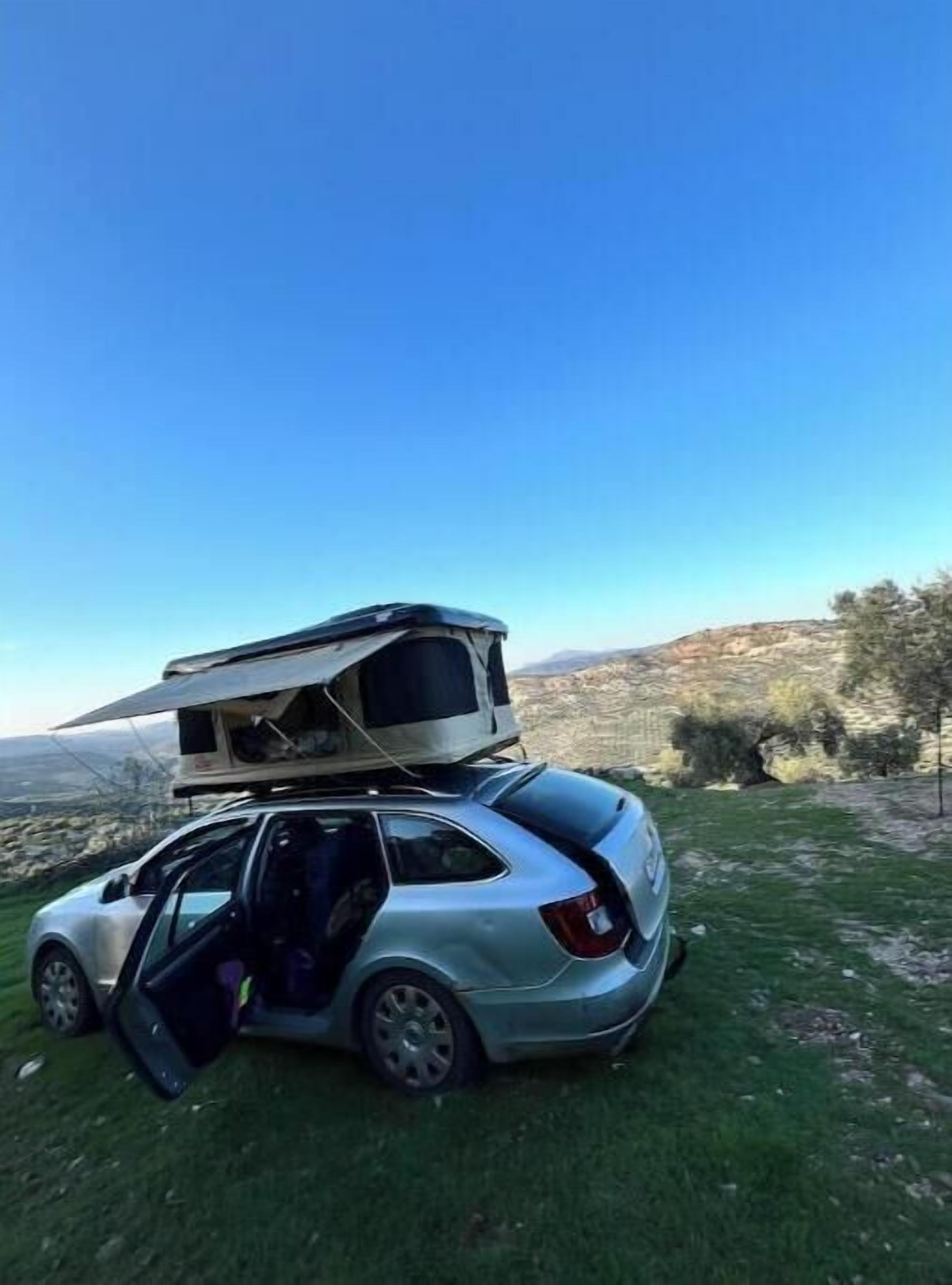 A car with a camper trailer attached.